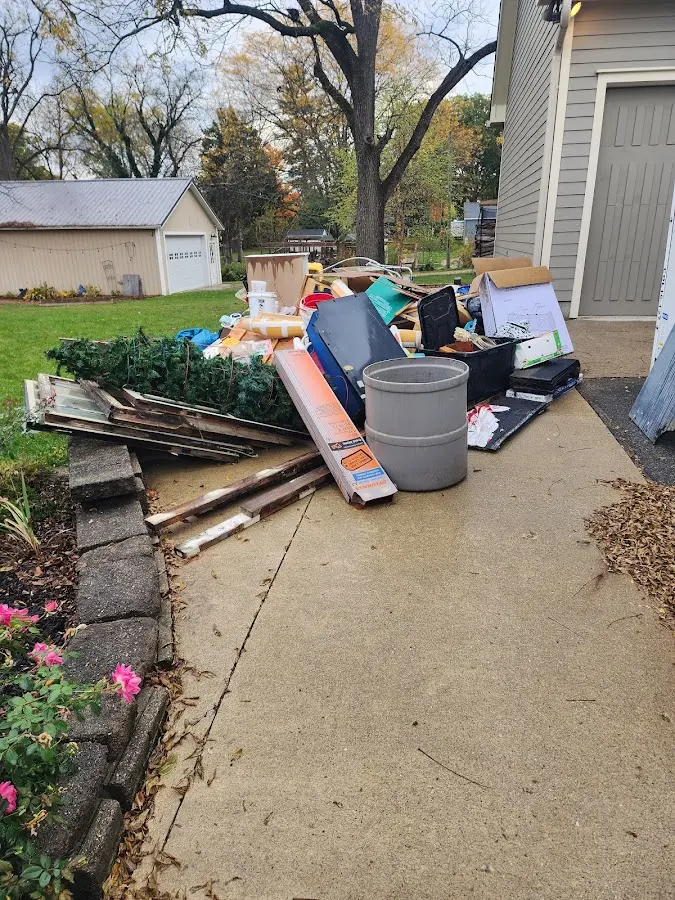 Dumpster being loaded with debris for Roofing Dumpster Rental in West Memphis